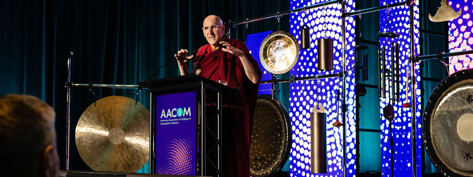 Barry Kerzin, MD, speaking at AACOM's conference in 2025.