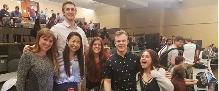 Theresa Sanborn with friends in a lecture hall