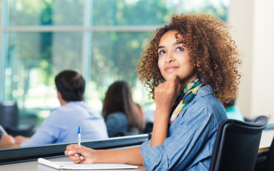 young woman looking up from her desk