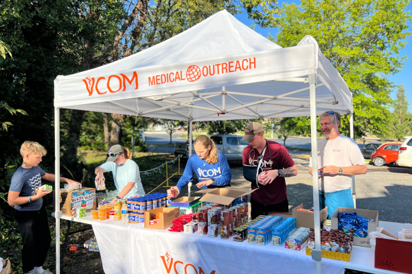 A group of people stands under a